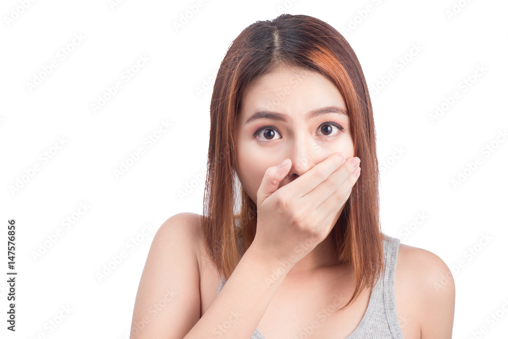 Young adult asian woman holding hand over her mouth over white background Young adult asian woman holding hand over her mouth over white background