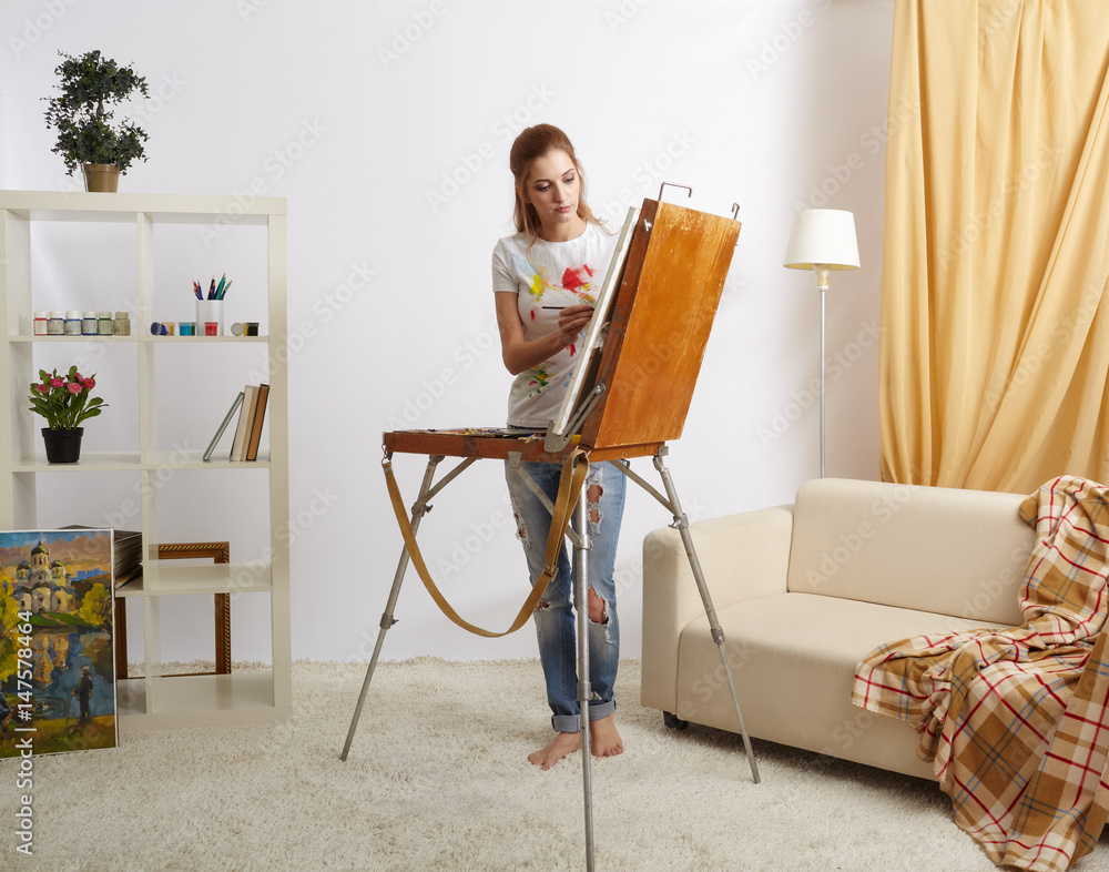 Painter female with wooden sketchbook and painting Painter female with wooden sketchbook and painting
