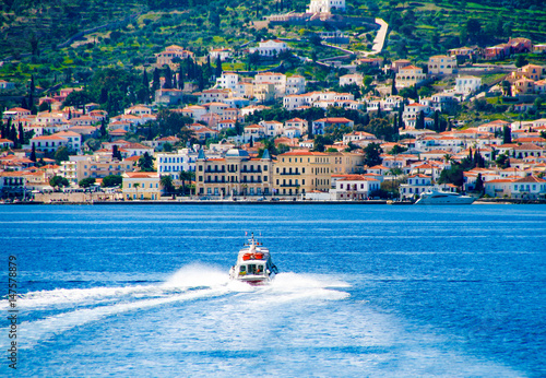 Small red motor boat transfer people to Spetses island, Greece