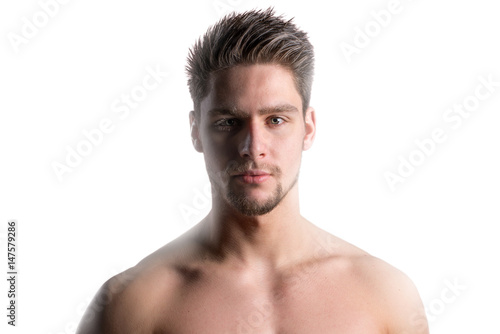 Close up portrait of a handsome young shirtless man posing against white background
