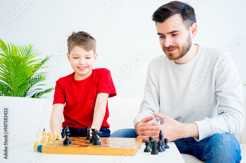 Father and son playing chess