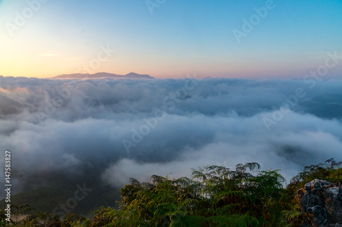 Fog and cloud on top of mountain with beautiful blue sky.