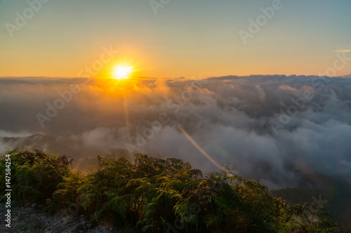 Sun rise view on top of mountain with Fog and cloud and beautiful blue sky.