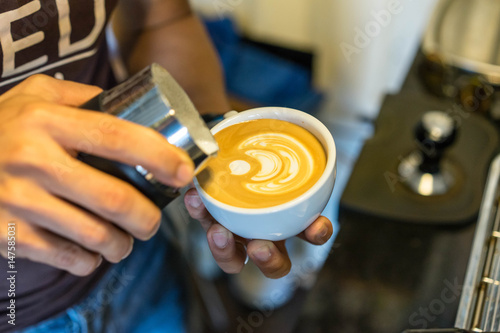 Hand Asian men Cup of coffee latte in coffee shop
