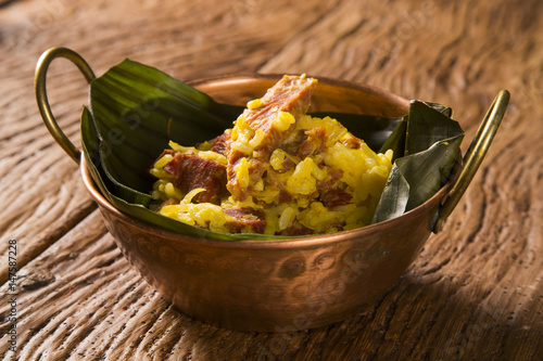 dried meat with rice in an old copper pot - Traditional bahia food photo