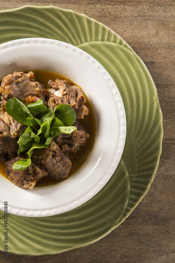 Brazilian traditional food called oxtail with arugula
