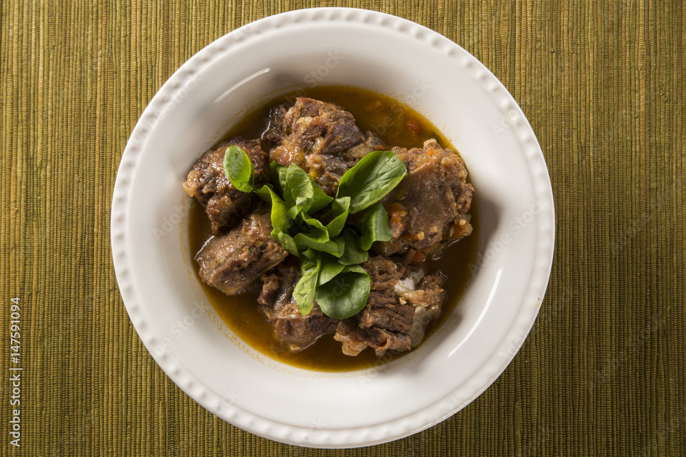 Brazilian traditional food called oxtail with arugula Brazilian traditional food called oxtail with arugula
