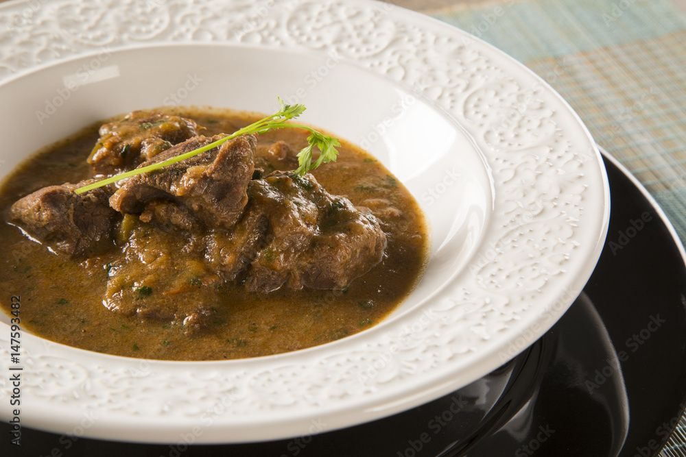 Rustic Stew meat with sauce in the white plate Rustic Stew meat with sauce in the white plate