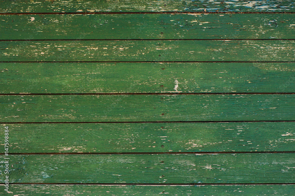 Green wooden texture background. Closeup of weathered painted wood planks of old house or barn. Horizontal color photography. Green wooden texture background. Closeup of weathered painted wood planks of old house or barn. Horizontal color photography.