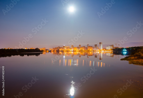Reflection of the night city on the water surface. © Sergej Ljashenko