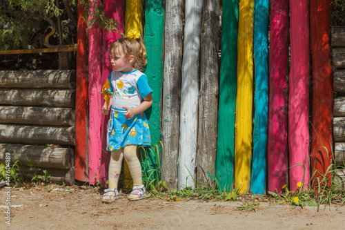 Girl near a colorful fence © skif55