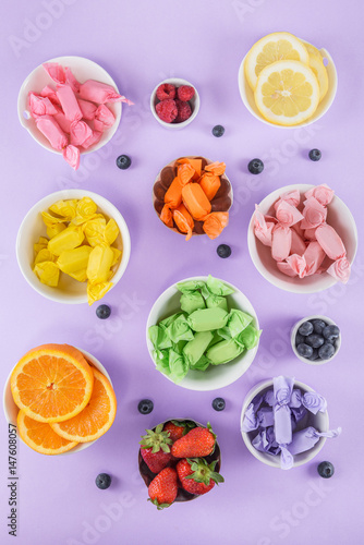 Candy and fruits on purple top