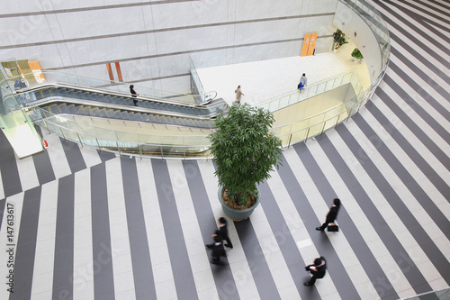 Aerial view of businessman walking at modern building lobby
