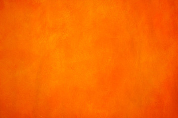 Vibrant, monochromatic, orange and yellow background. Saturated, warm colored acrylics on paper. Close up photo of hand painted abstract painting.