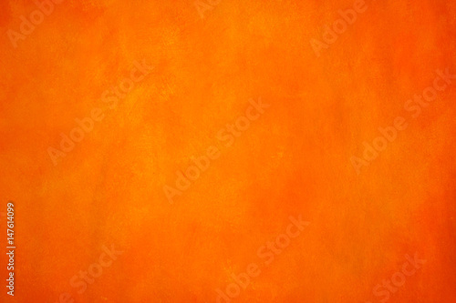 Vibrant, monochromatic, orange and yellow background. Saturated, warm colored acrylics on paper. Close up photo of hand painted abstract painting.