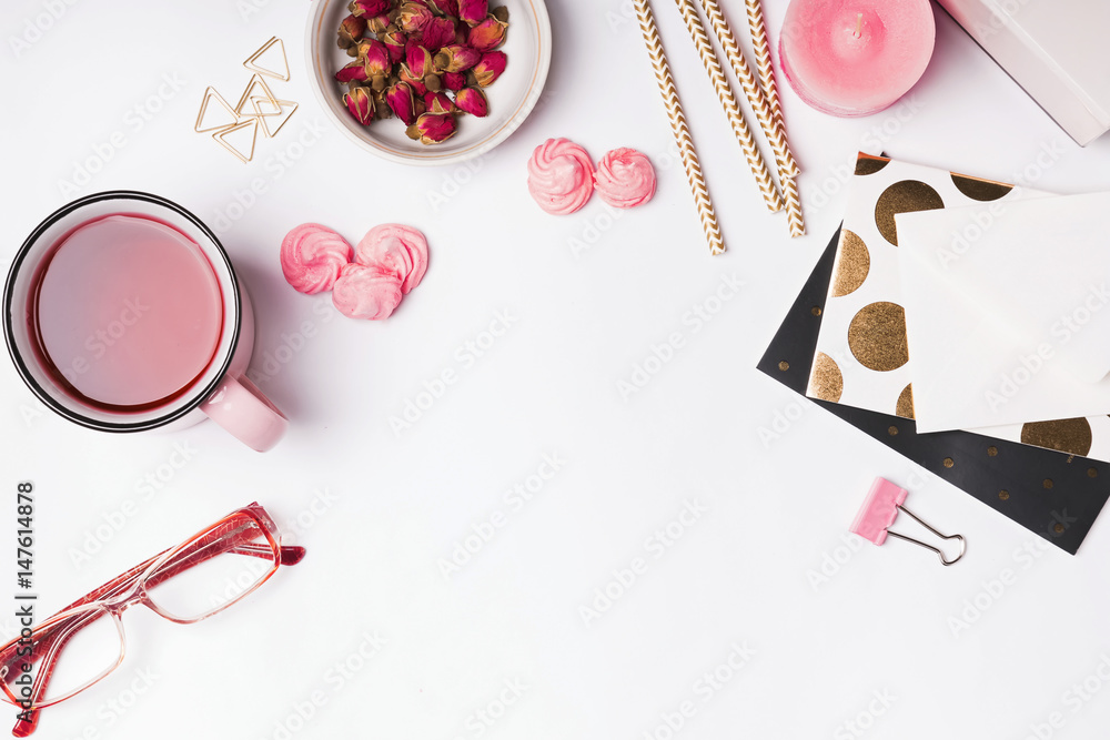 Pink colored objects, herbal tea and dry roses on white background Pink colored objects, herbal tea and dry roses on white background