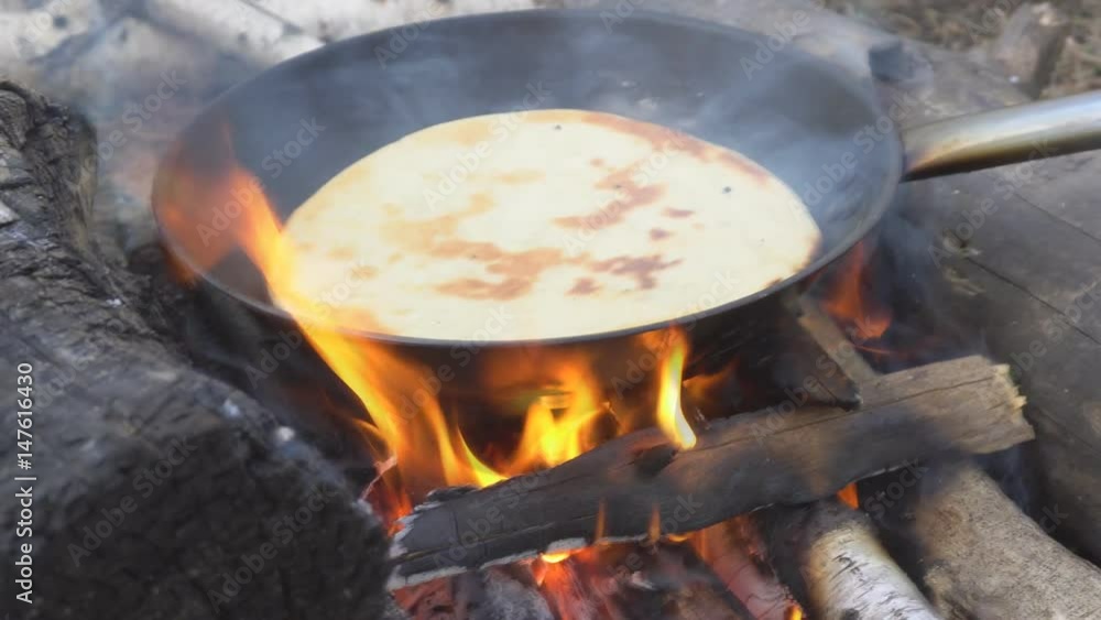 Pita on frying pan on bonfire. Natural healthy food concept. Slow motion. Pita on frying pan on bonfire. Natural healthy food concept. Slow motion.