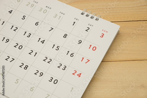desktop calendar putting on wooden background. this image for business accessory concept