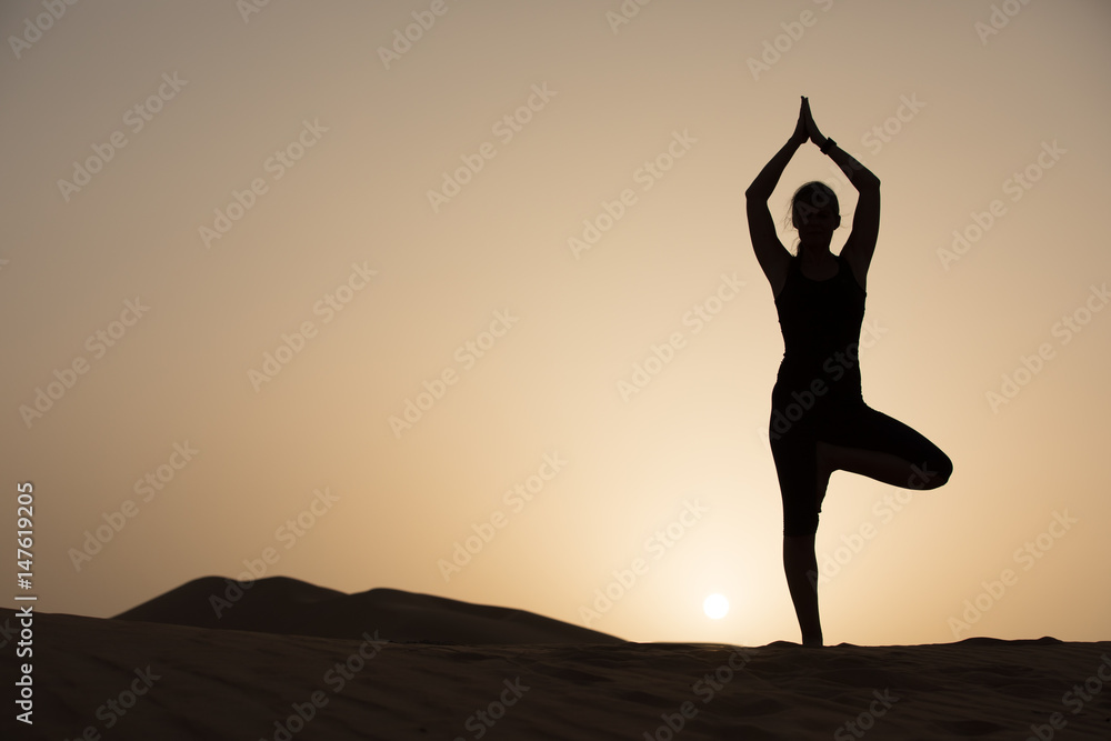 Woman exercising in the desert.