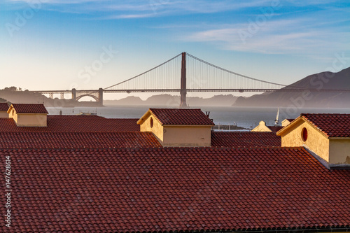The golden gate bridge over the rooftops of the Presidio in San Francisco