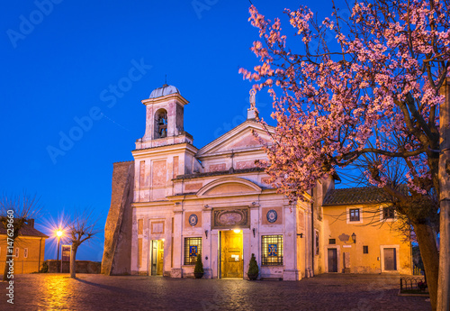 Photography Church and Shrine of the Mother of Divine Love (Madonna del Divino Amore) outside Rome, Italy, at blue hour with spring blossom trees