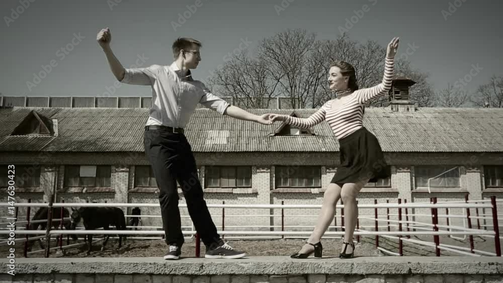 young couple dancing swing outside, the girl's skirt is flying in the wind; looping cinemagraph young couple dancing swing outside, the girl's skirt is flying in the wind; looping cinemagraph