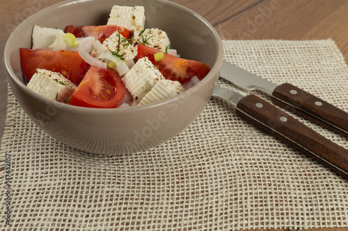 organic cheese and tomatoes salad on wooden table