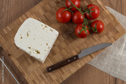organic cheese and tomatoes on wooden table top view 