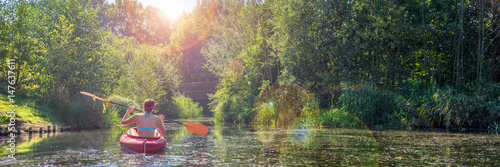 Girl in a kayak and sunny weather, panorama