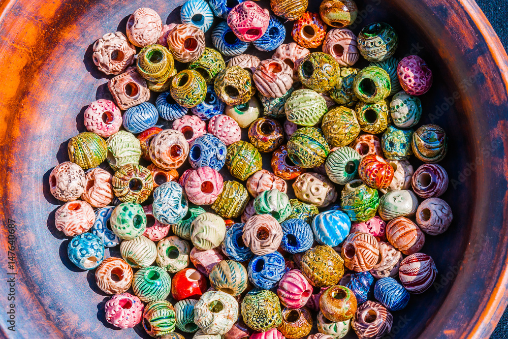 Colorful beads in a earthen dish