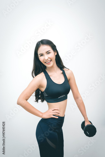 Beautiful Woman Lifting Dumbbells in Weight Training Fitness - Sport and Lifestyle Concept