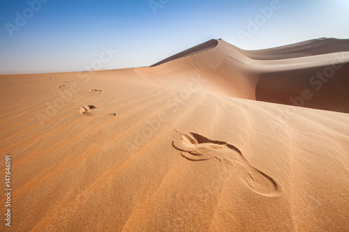 Human foot prints on sand dunes in the arabian desert 