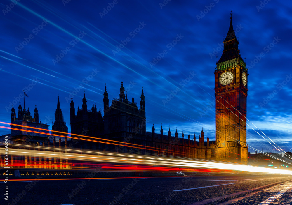 Big Ben, one of the most prominent symbols of both London and England, as shown at night along with the lights of the cars passing by Big Ben, one of the most prominent symbols of both London and England, as shown at night along with the lights of the cars passing by