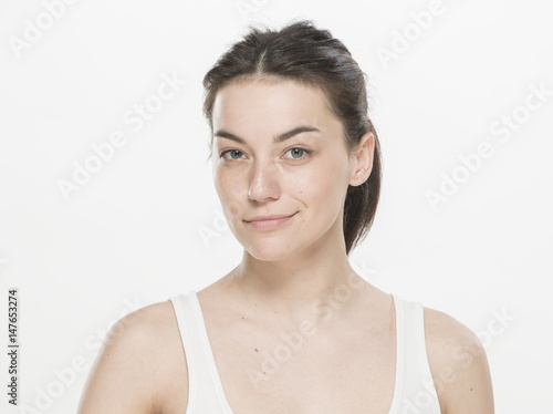 Portrait of a beautiful young women, dressed white T-shirt , slightly smiling, isolated on white