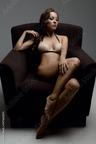 Girl in lace lingerie sitting in the chair leaning back © bestsenny