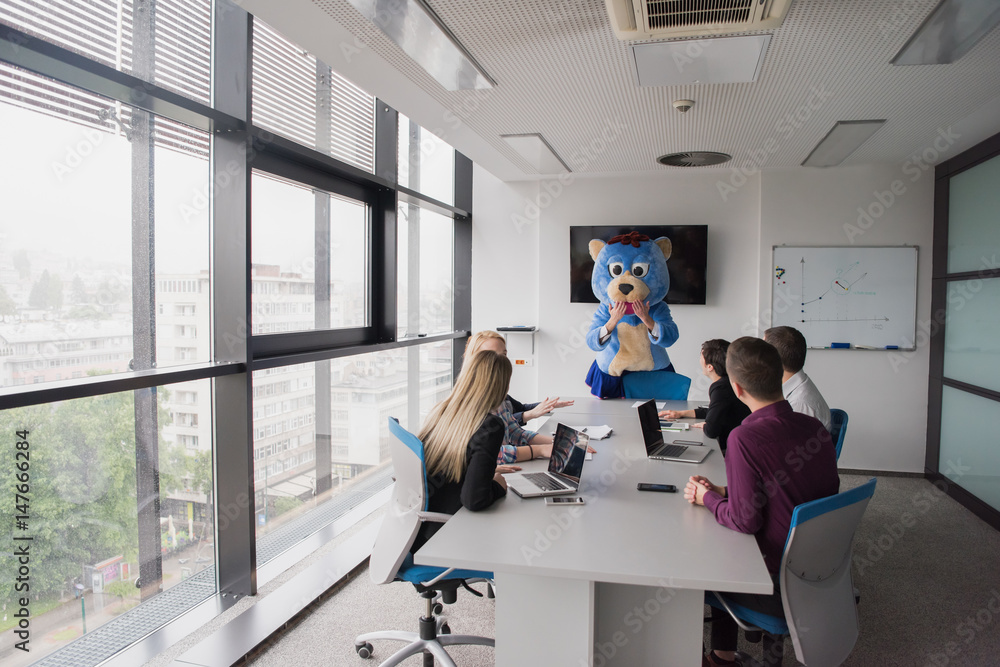 boss dresed as bear having fun with business people in trendy office - obrazy, fototapety, plakaty 