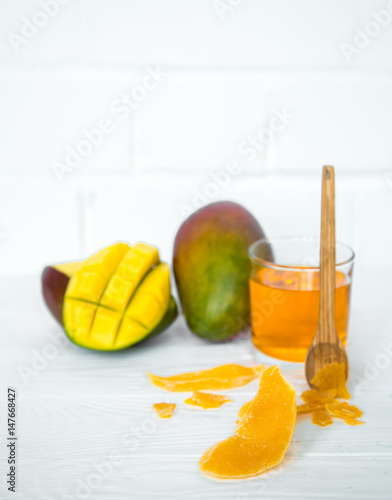 Mango on a white wooden background with juice
