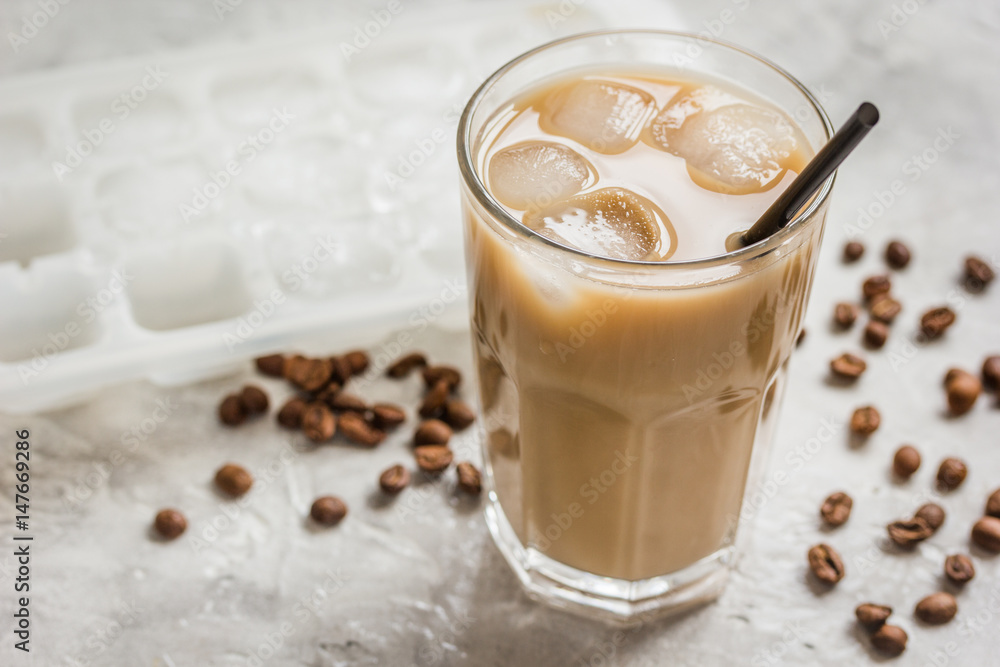 coffee ice cubes and beans with latte on stone desk background coffee ice cubes and beans with latte on stone desk background