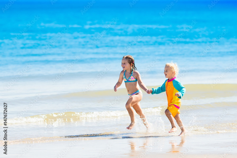 Kids run and play on tropical beach