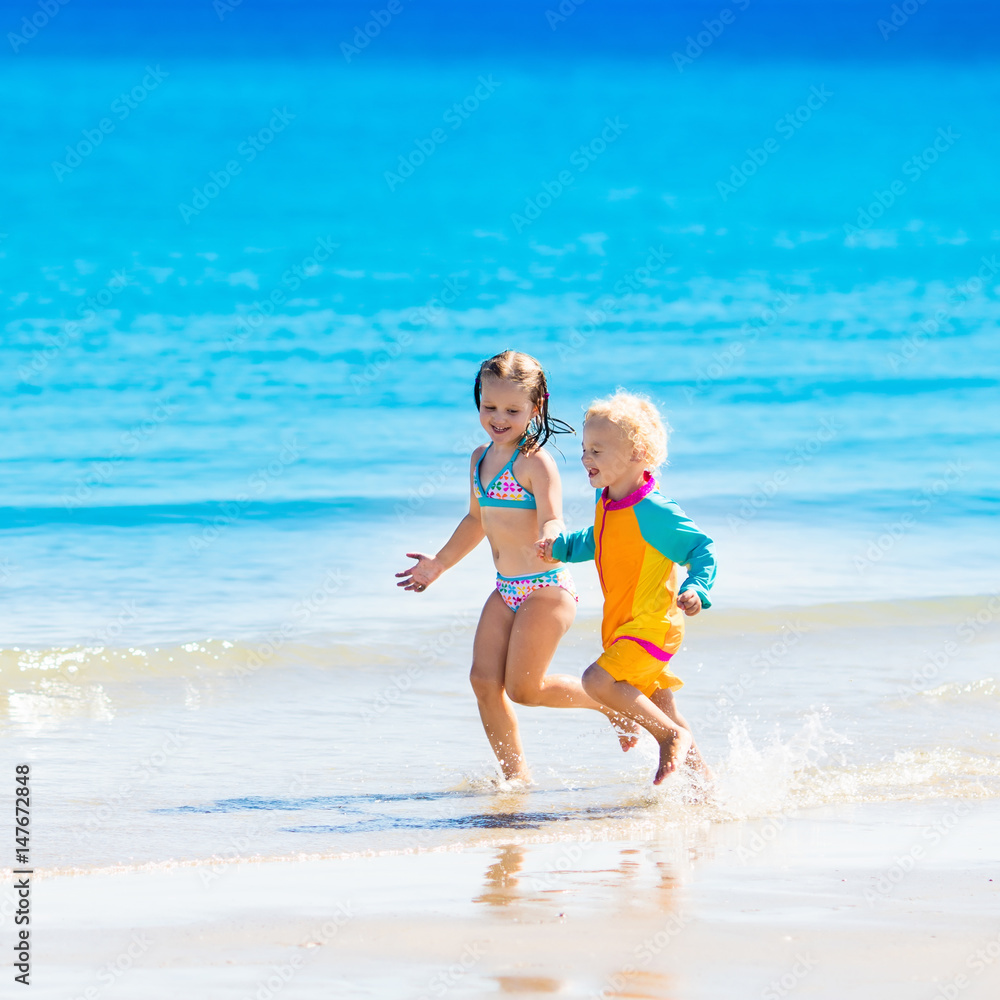 Kids run and play on tropical beach