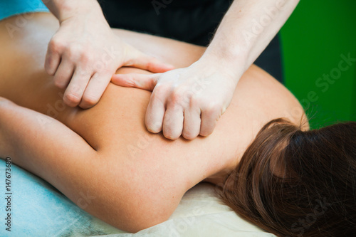 Male hands massaging female body.