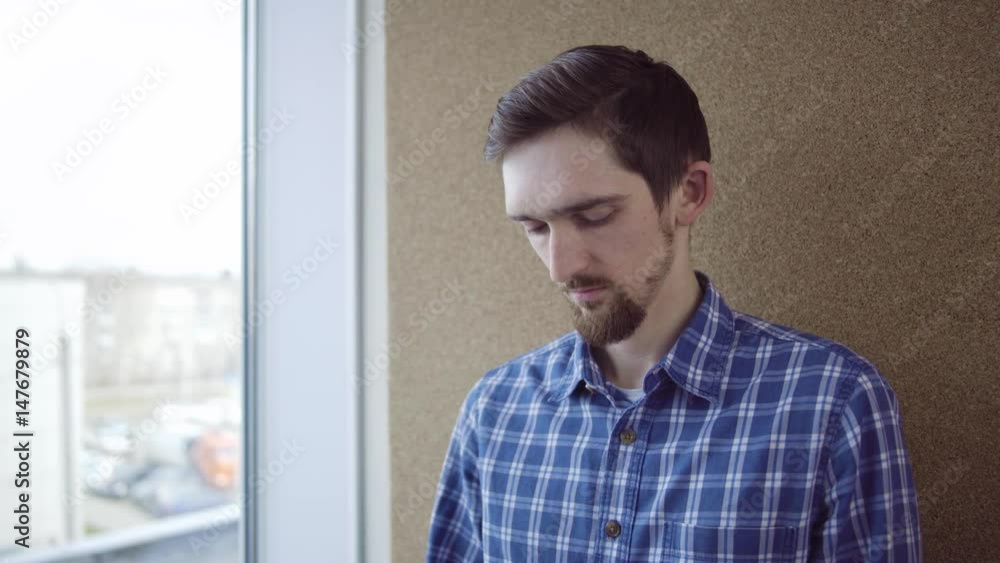 Pensive man looking through the window Pensive man looking through the window