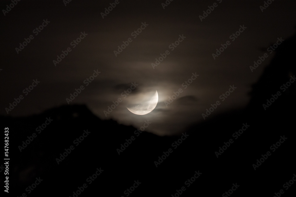 Zoomed in shot of the moon, with some mist and clouds
