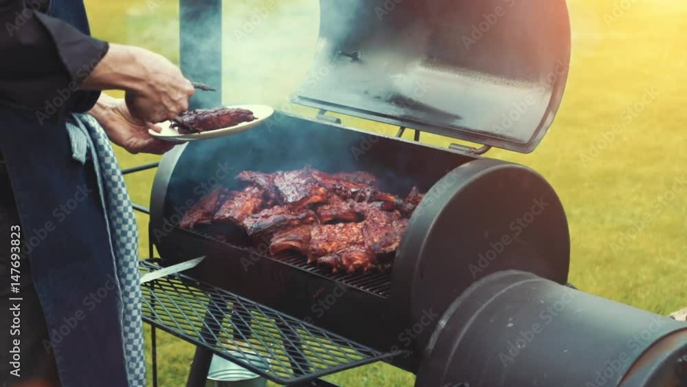 Cooking / smoking delicious juicy meat steaks and sausages on the grill