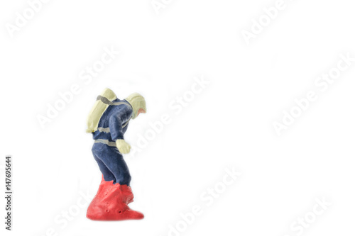 Miniature people firefightes in hazmat suits construction concept