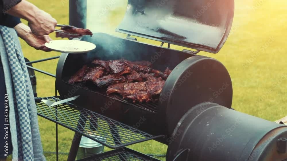 Cooking / smoking delicious juicy meat steaks and sausages on the grill