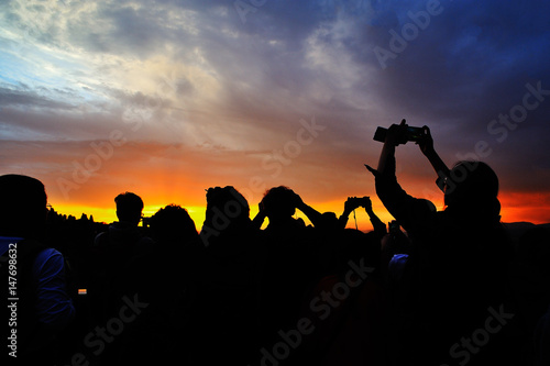 Silhouette with people with phone and camera taking photos