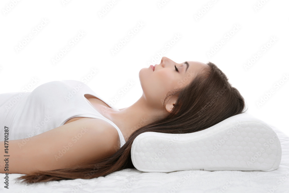 Young woman sleeping on bed with orthopedic pillow against white background. Healthy posture concept Young woman sleeping on bed with orthopedic pillow against white background. Healthy posture concept
