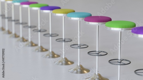 Line of Modern Variously Colored Leather and Raw Metal Bar Stools on Concrete