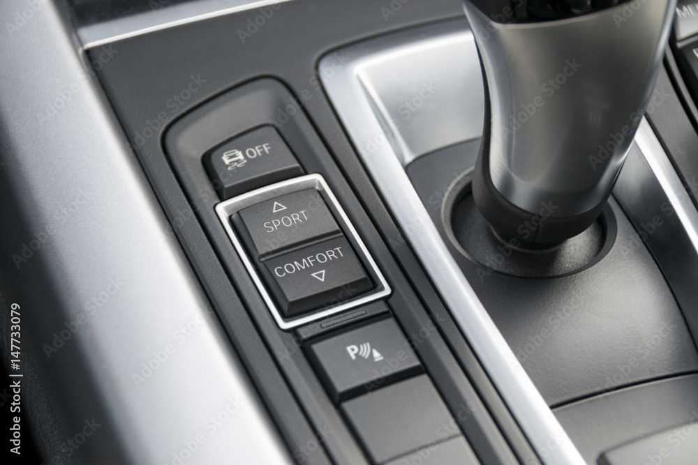 track control buttons near automatic gear stick of a modern car, car interior. details